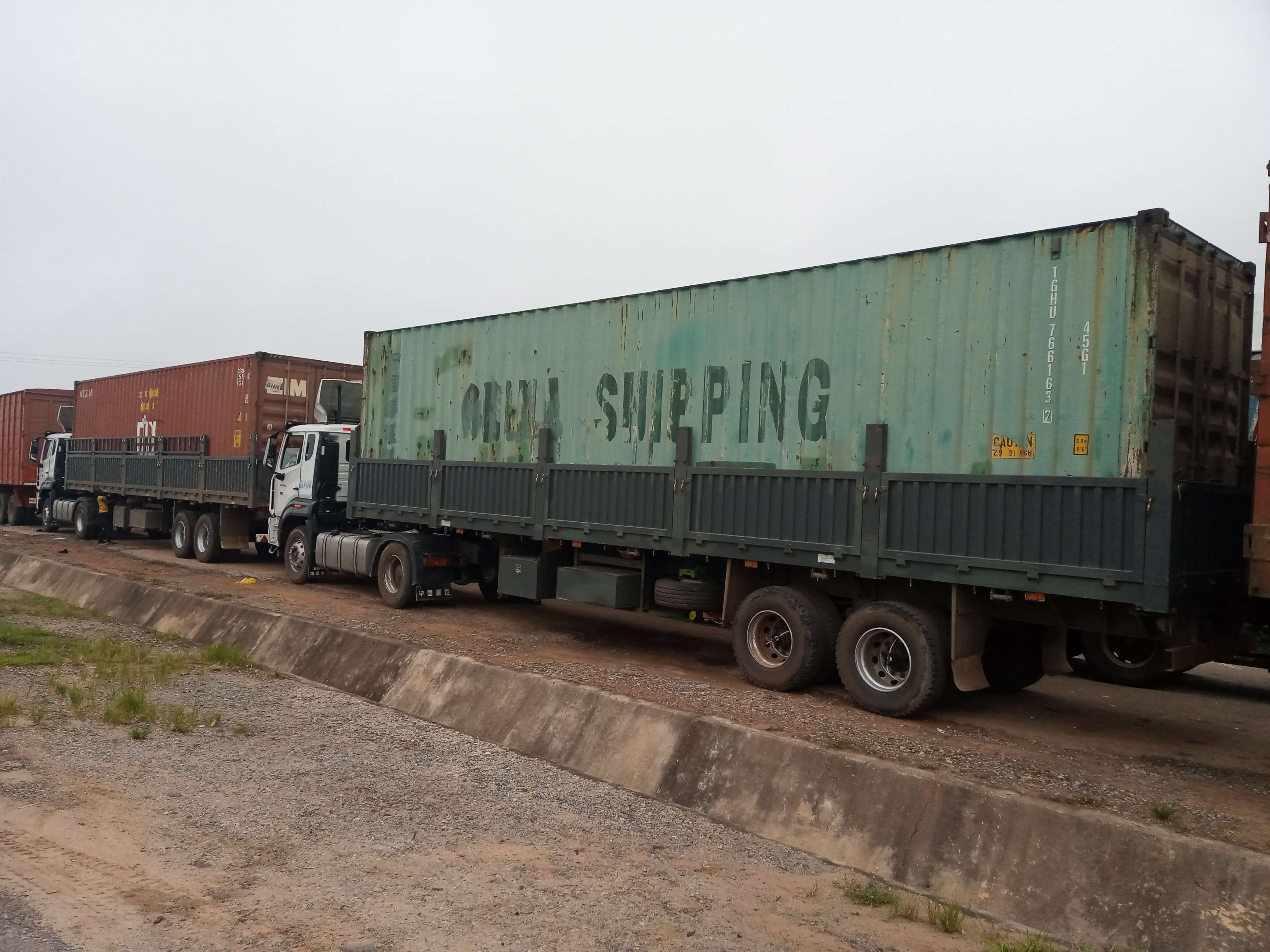 Korlun 40ft covered trailer hauling a shipping container