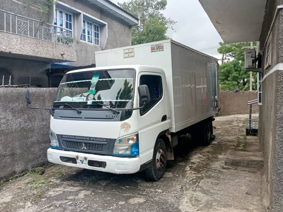 Korlun mini box truck parked outside a residence in Abuja