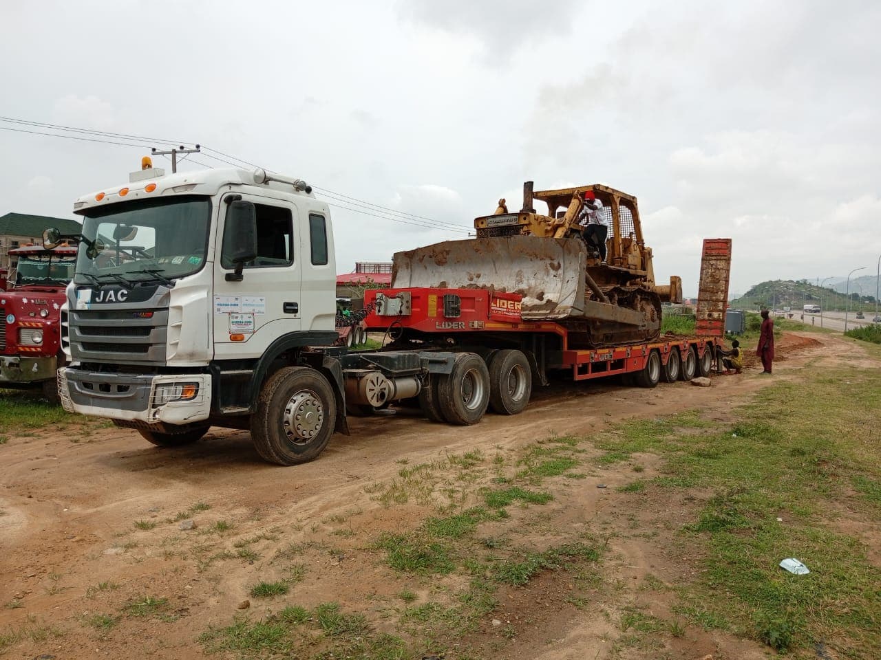 Korlun prime mover hauling a bulldozer on a low-bed trailer
