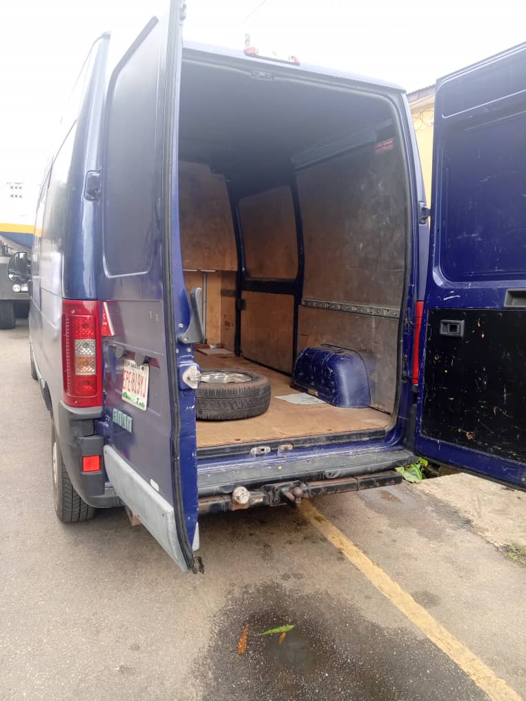 Rear cargo doors open on a Korlun large van